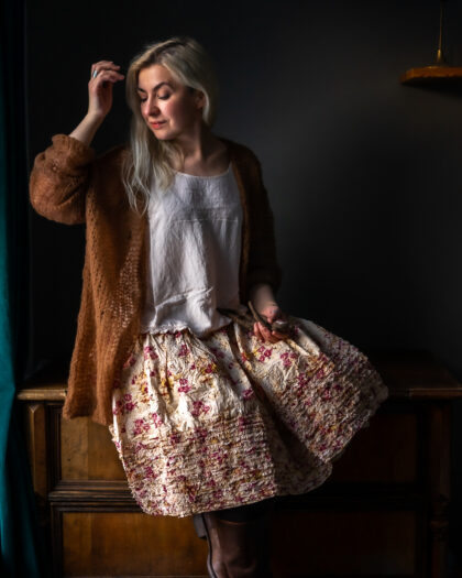 Ewa i Walla Virpa skirt SS23 worn by a girl sitting in the dark room