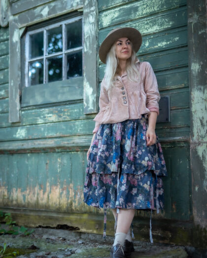 Lady with light pink velvet jacket and Ewa i Walla floral printed skirt