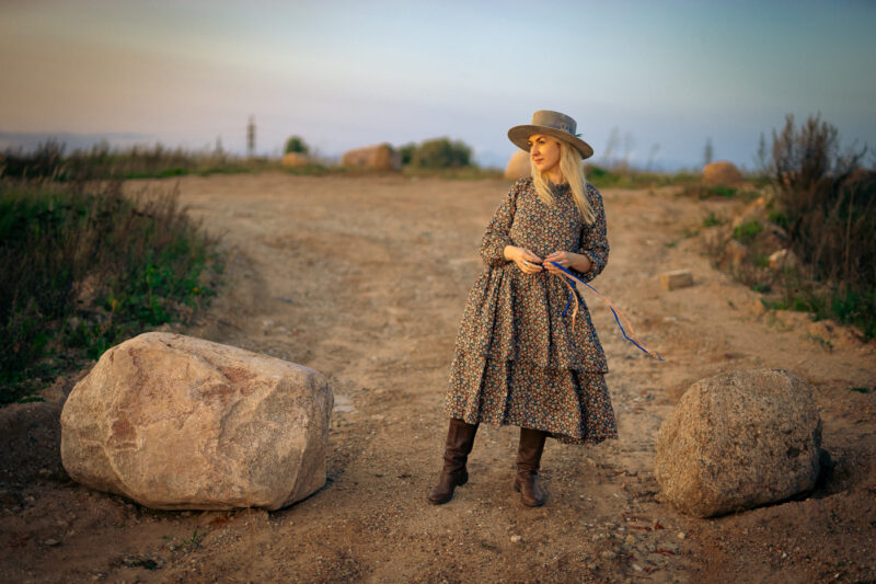 Lotten dress Ewa i Walla AW23 lady standing between two big rocks in flower printed dress